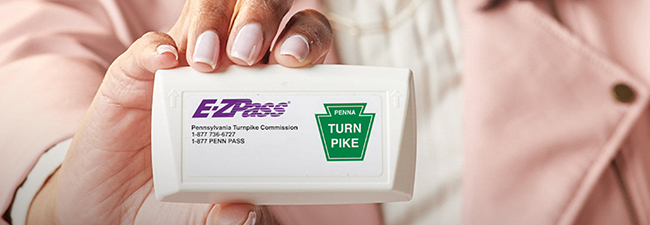 Woman holding E-ZPass transponder